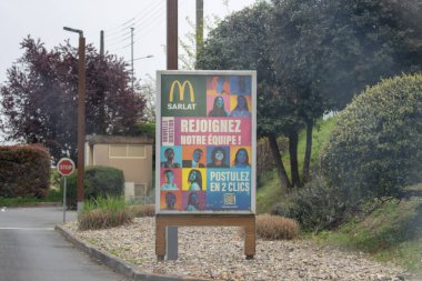 France, 07 April 2024: McDonald's recruitment billboard in Sarlat clipart
