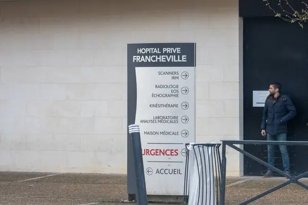 France March 2024 Man Stands Private Hospital Showcasing Various Healthcare — Stock Photo, Image