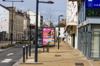 France, 10 March 2024: Urban street scene with digital education advertisement in Perigueux clipart