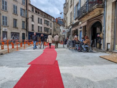 France, May 3, 2024: Outdoor cafe on historic street with red carpet event in European city clipart