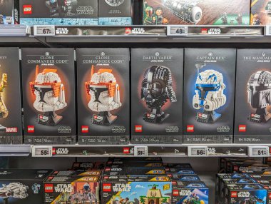 France, April 26, 2024: Star Wars LEGO helmet models on display in a retail store. clipart