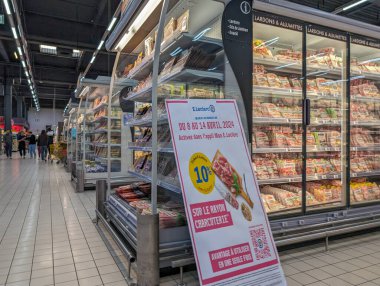 France, April 11, 2024: Interior view of Leclerc supermarket showcasing promotional display and refrigerated meat section