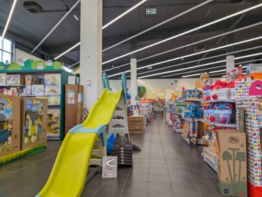 Interior of a Modern Toy Store with Colorful Shelves and Children's Slide