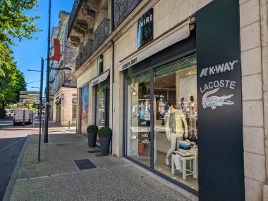 Fransa, 9 Mayıs 2024: Lacoste ve K-Way kentsel bir sokakta güneşli bir günde mağaza vitrinleri.