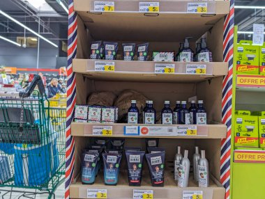 France, 08 May 2024: Shelf displaying men's grooming products in a supermarket clipart