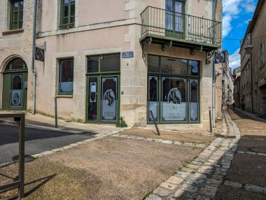 France, 08 May 2024: Corner view of a historic building with a shopfront clipart