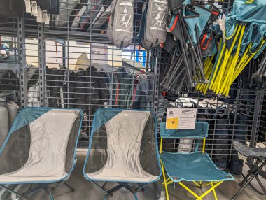 France, 09 May 2024: Display of folding chairs and camping gear in a store clipart