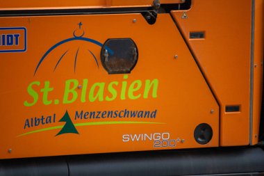 Germany, 13, June, 2024: St. Blasien Albtal Menzenschwand signage on orange vehicle clipart
