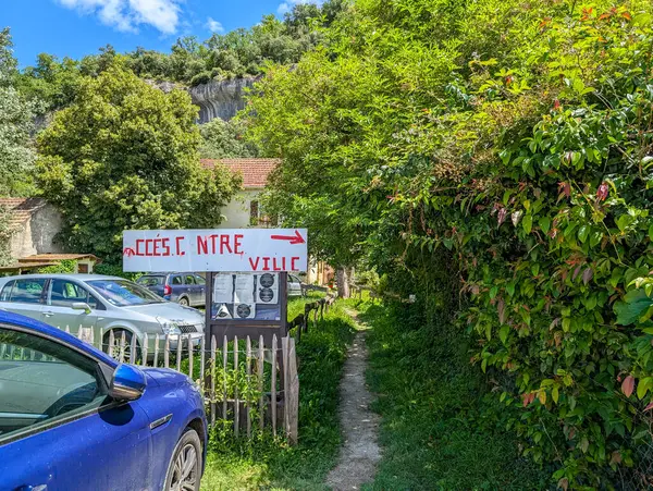 stock image France, 7, July, 2024: Village access sign with cars and greenery