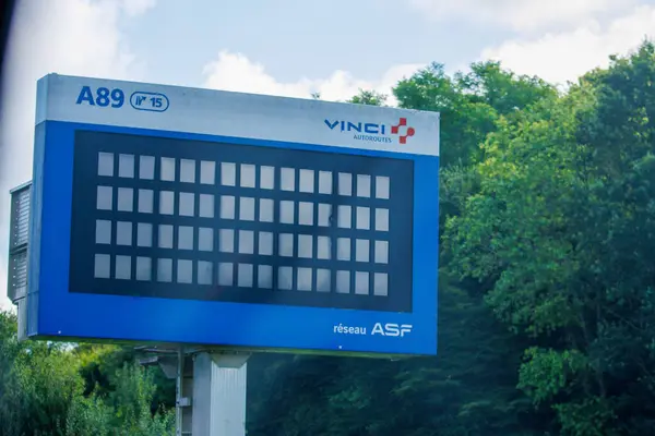 Stock image France, 1 July 2024: Vinci Autoroutes A89 electronic road sign in a rural area