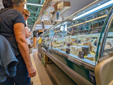 Fransa, 9 Mayıs 2024: Müşteriler yerel pazarda peynir seçiyor