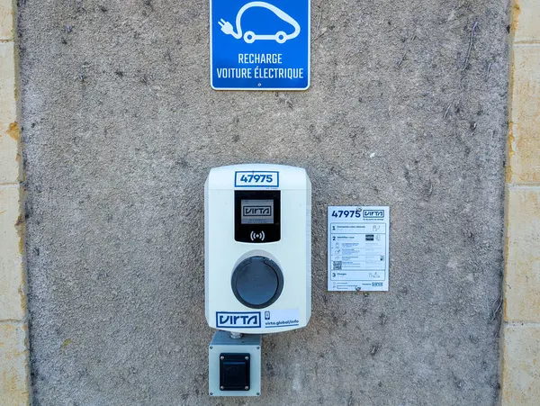 stock image France, 1 July 2024: Electric vehicle charging station on a concrete wall