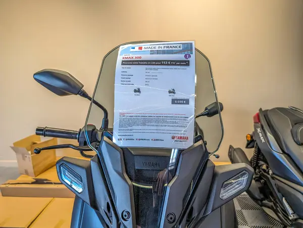 stock image France, 18 May 2024: Yamaha XMAX 300 scooter display with price tag in a showroom