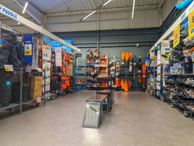 France, 9 May 2024: Sporting goods store aisle with outdoor equipment and paddles clipart