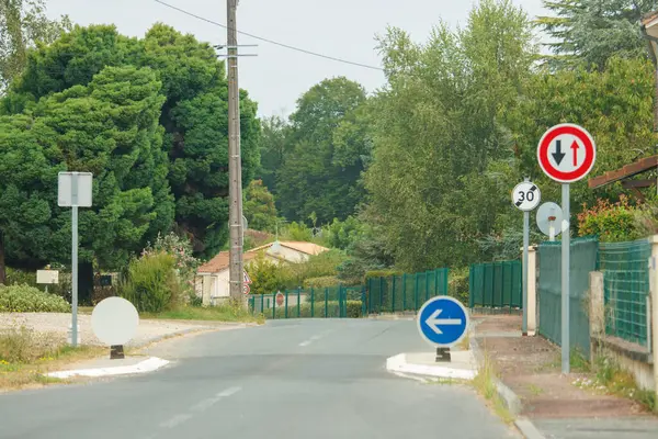 stock image France, 15 August 2024: Traffic signs on a suburban road near residential area