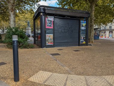 Fransa, 24 Ağustos 2024: Kapalı gazete büfesi şehir parkı ortamında grafiti ile