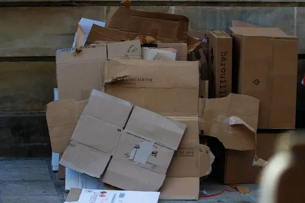 stock image France, 16 August 2024: Pile of cardboard boxes discarded on a sidewalk for recycling