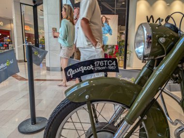 France, 20 August 2024: Close-up of vintage Peugeot 176TC4 motorcycle displayed in a shopping mall clipart