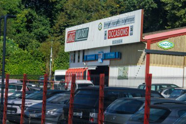 France, 8 September 2024: Exterior of a used car dealership with vehicles parked outside clipart