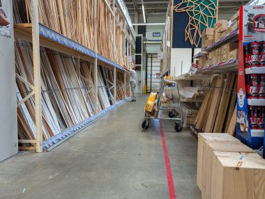 France, 13 July 2024 : Home improvement warehouse aisle showcasing lumber and construction materials clipart