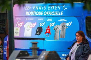 France, 22 May 2024 : Official Paris 2024 Olympic Merchandise Advertisement Displayed on a Vehicle clipart