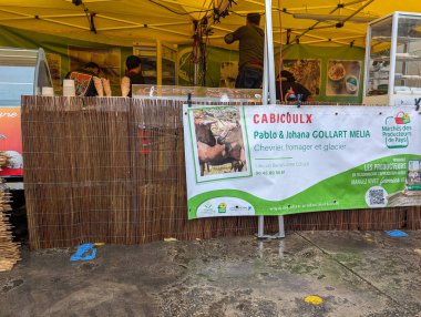 France, 27 September 2024 : Market Stall Promoting Cabicoulx Cheeses with Banners and Decorations clipart