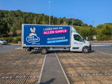 France, 20 August 2024: Rent and Drop moving truck parked in a lot promoting one-way rental services clipart