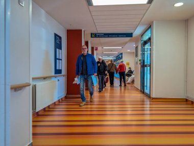 Fransa, 21 Ekim 2024: Bir tıbbi tesiste yürüyen insanlarla dolu koridor