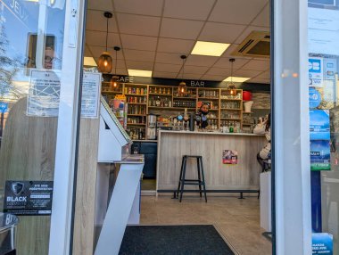 France, 06 November 2024 : Small cafe bar interior with wooden counter and shelves clipart