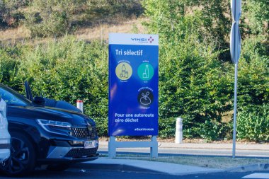 France, 10 August 2024: Selective sorting sign promoting zero waste on a highway by Vinci Autoroutes clipart