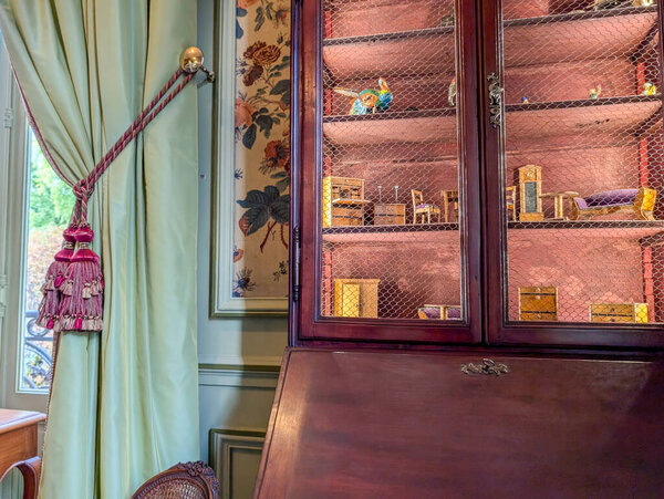 France, 22 September 2024 : Elegant room with ornate cabinet and decorative tassel accents