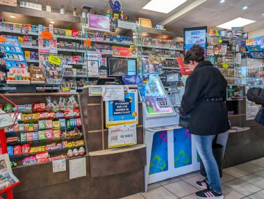 Customers at a busy convenience store in Dordogne France clipart