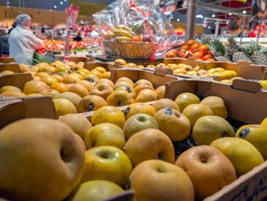 France, 14 December 2024 : Fresh produce displayed in boxes at a bustling grocery store clipart