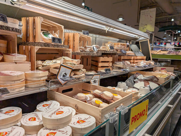 France, 03 December 2024 : Cheese selection on display at supermarket with promotional sign