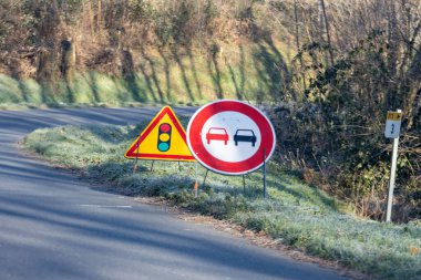 France, 31 December 2024 : Road signs warn of traffic light and no overtaking zone clipart