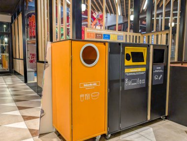 France, 05 December 2024 : Recycling bins inside a modern restaurant waste management station area clipart