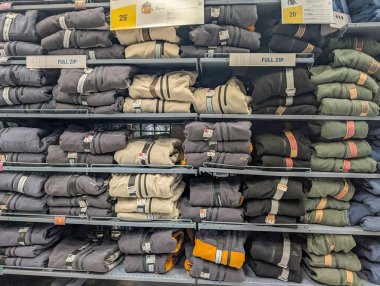 France, 07 December 2024 : Stacked hoodies in clothing store display showcasing various colors clipart