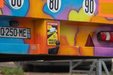 France, 17 December 2024 : Colorful vehicle rear view with French warning signs displayed clipart