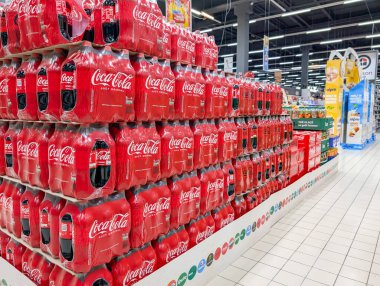 France, 23 January 2025 : Coca Cola bottles stacked in supermarket aisle display showcase clipart