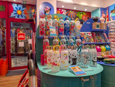 France, Lyon 04 February 2025 : Colorful water bottles displayed in a vibrant store interior. clipart