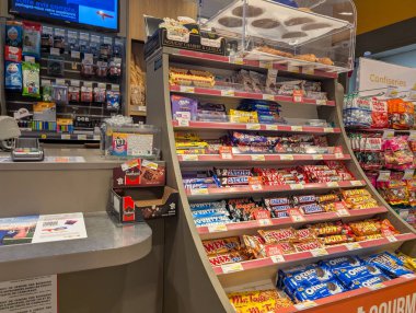 France, 14 January 2025 : Candy display shelf in store next to checkout counter clipart