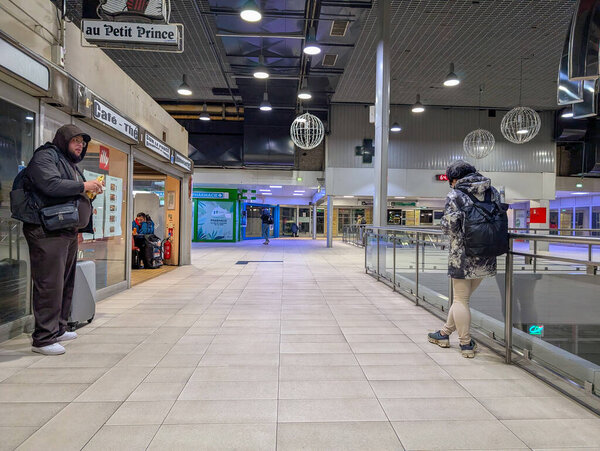 Франция, Лион 04 февраля 2025 года: Два человека стоят в помещении общественного прохода.