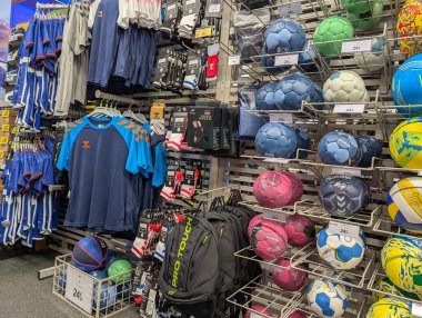 France, 02 January 2025 : Variety of sportswear gear and balls displayed in store clipart