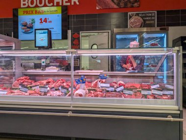 Fransa, 18 Nisan 2025: Kasap tezgahının arkasında çalışan renkli kasap dükkanı