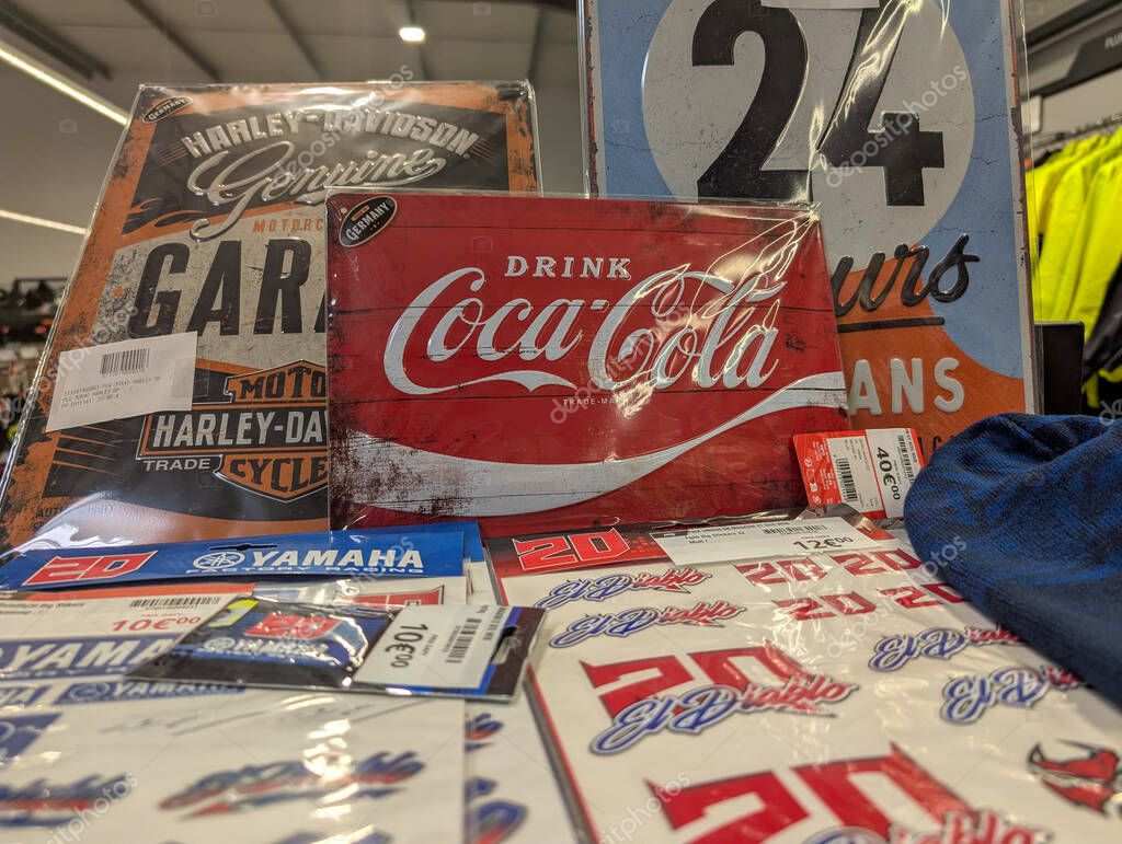 France, 29 April 2025 : Coca Cola retro sign surrounded by Yamaha Harley Davidson memorabilia