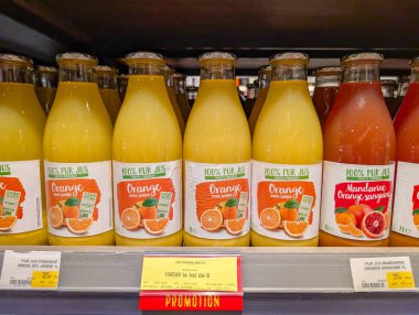 France, 17 May 2025 : Bottles of orange juice and blood orange juice on display shelf