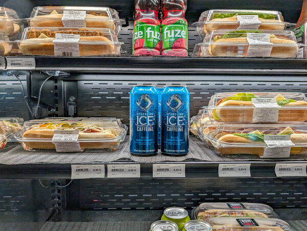 Quebec, Canada, 09 July 2025 : Packaged sandwiches, energy drinks, iced tea, refrigerated shelf, convenience food display