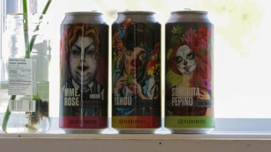 Kanada, 20 Eylül 2025: Üç renkli içecek kutusu ve bir cam kavanoz düzenleme.