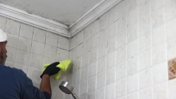 Man Blue Sweatshirt White Cap Cleaning Mold Bathroom Ceiling Hygiene — Stock Video