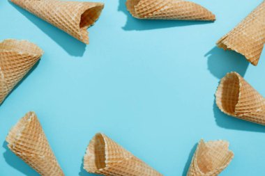 Ice cream cones on color background. Conceptual food. Top View 